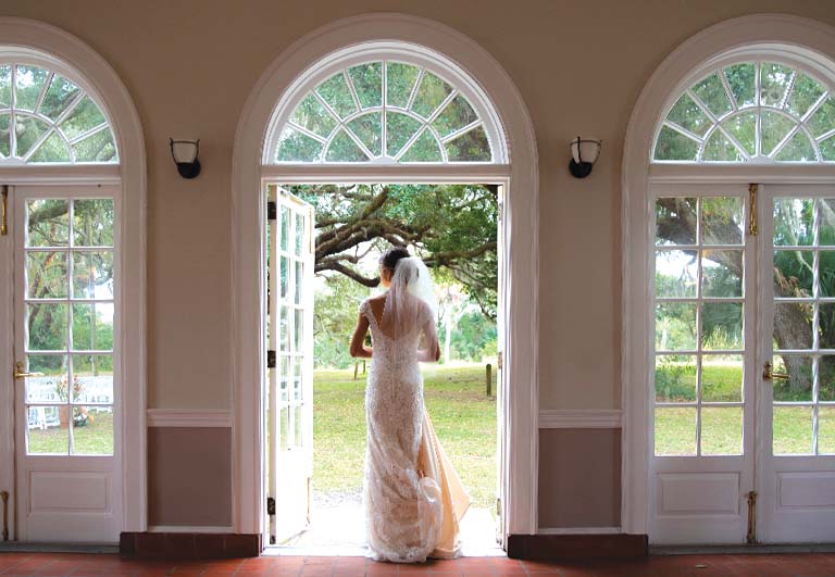bride standing in the doorway of The Ribault Club for wedding